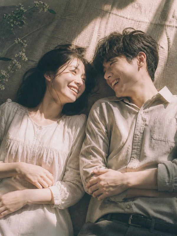 Adult couple laughing together in warm light